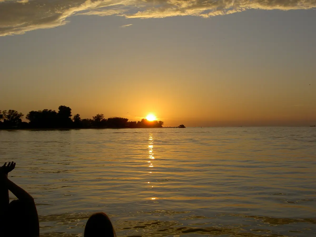 Sun setting over calm water near the Anna Maria City Pier