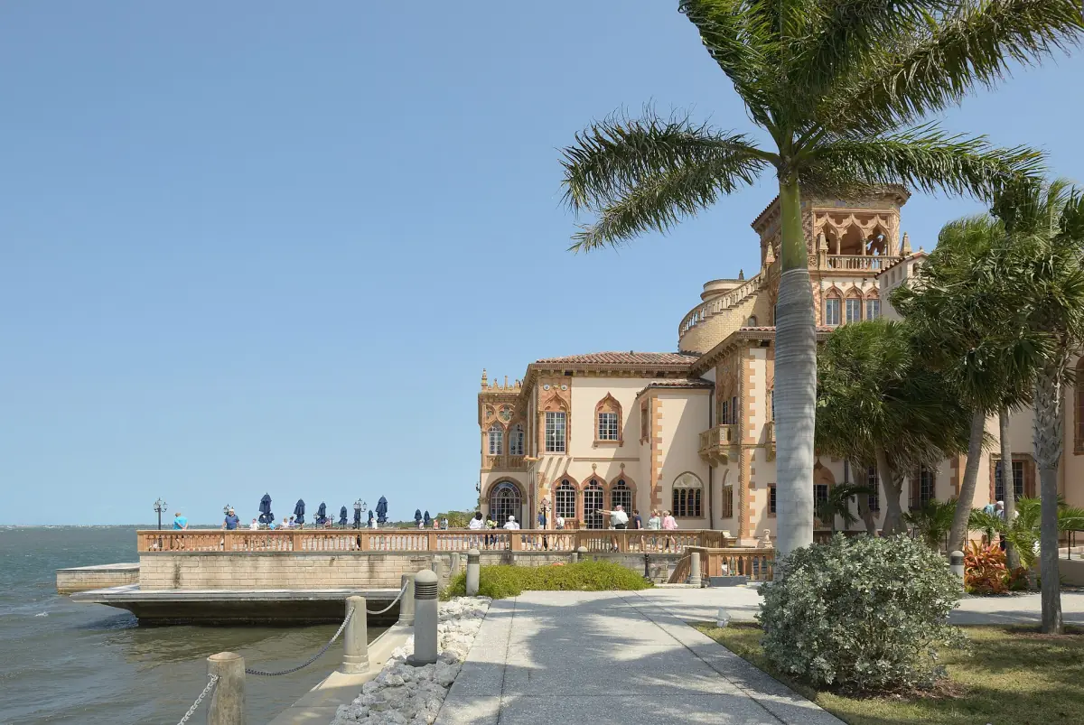 Ca' d'Zan mansion and its marble terrace beside the bay under tall palms