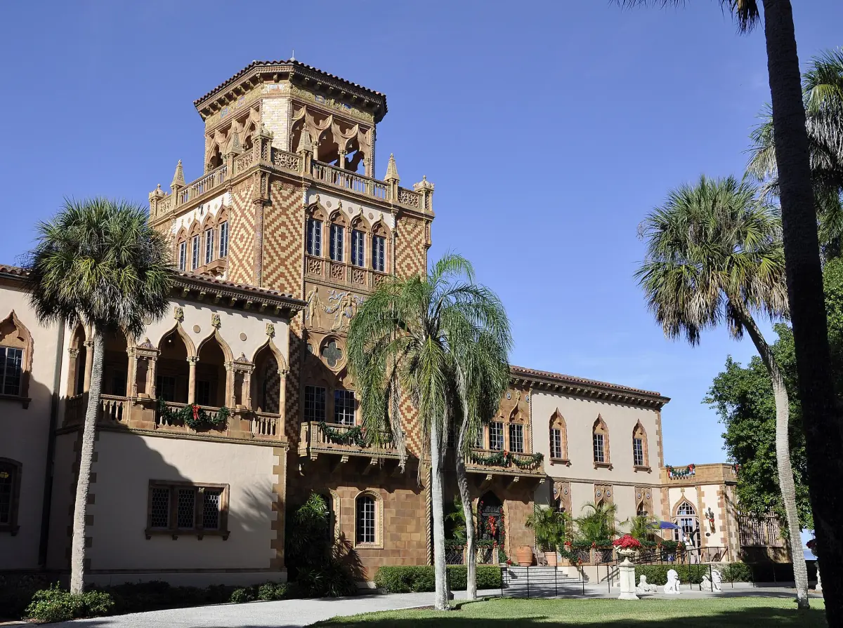 Tower and ornate walls of the Ca' d'Zan mansion among palm trees