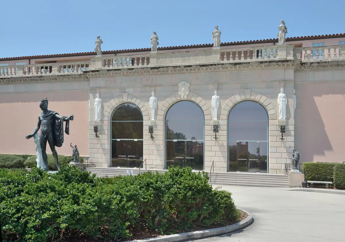 Arched stone facade of the Ringling Museum with classical statues